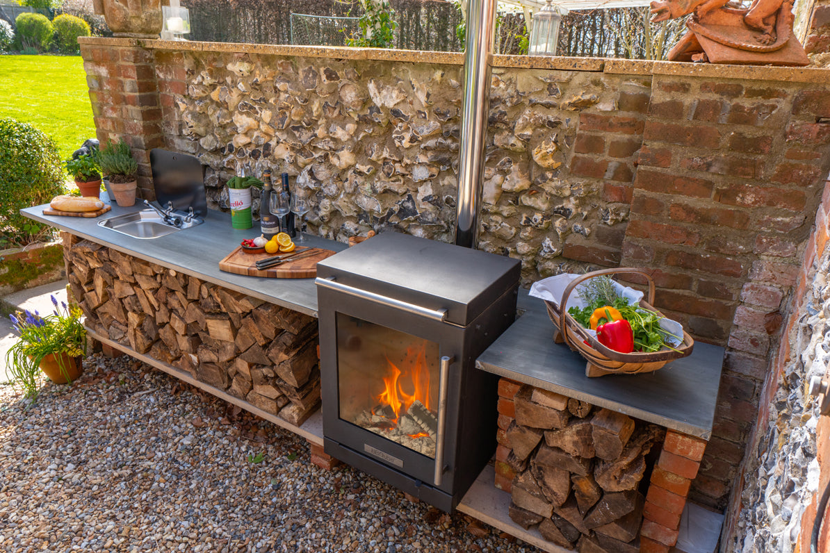 BBQube wood-burning stove and barbecue integrated into an outdoor kitchen