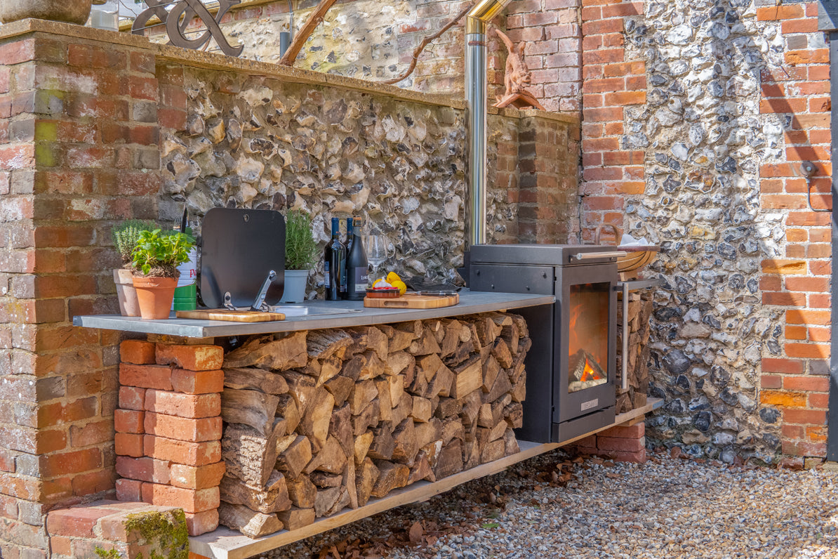 BBQube wood-burning stove and barbecue integrated into an outdoor kitchen