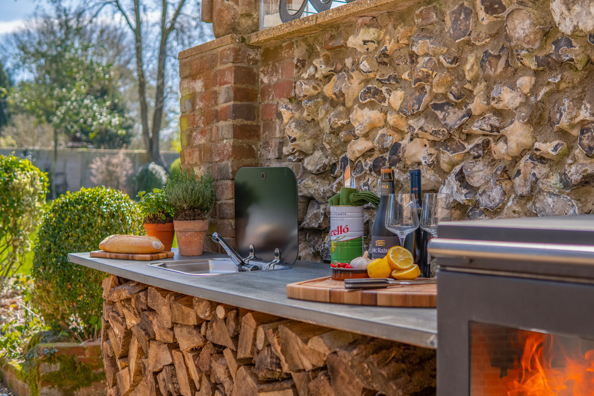 BBQube wood-burning stove and barbecue integrated into an outdoor kitchen